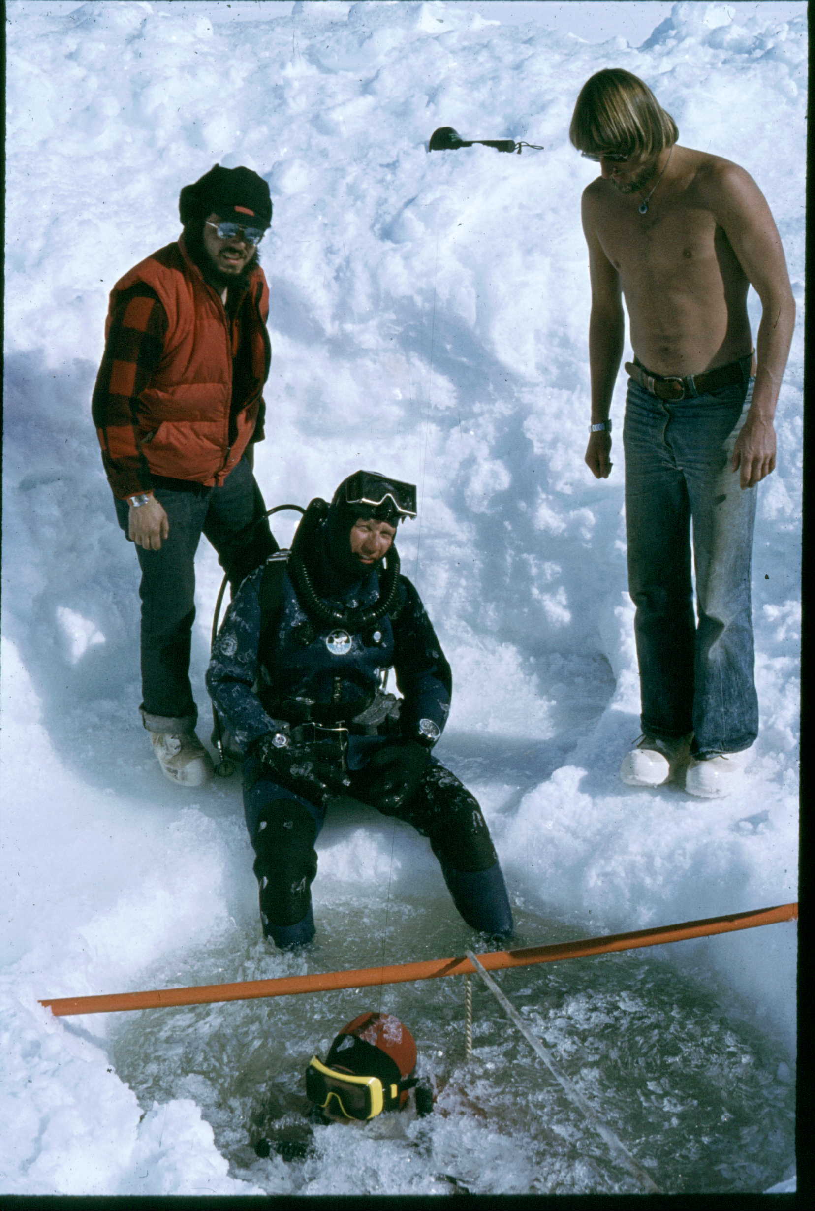 1978 diving expedition to observe Weddell seals under the ice. Dan Costa surfaces from a dive while Gerry Kooyman gets ready to submerge. Photo credit: Dan Costa.